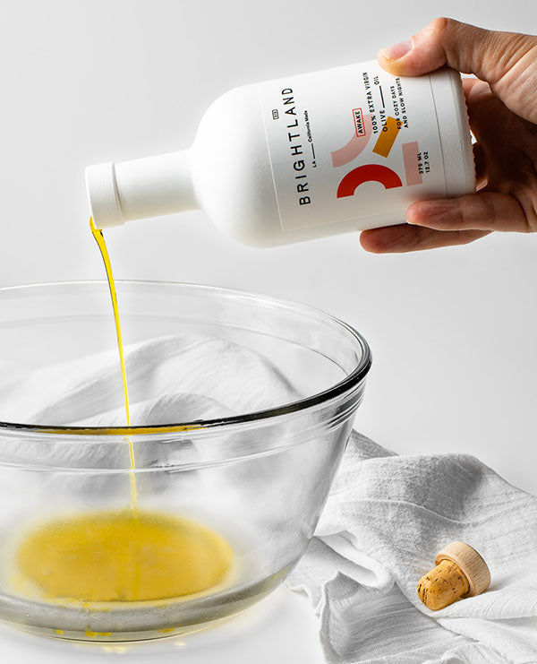 pouring olive oil into bowl