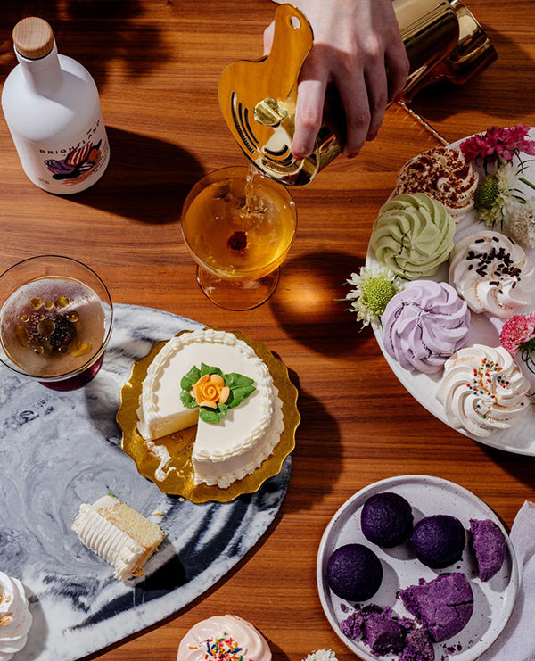 a bottle of olive oil next to an assortment of baked goods