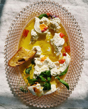 a plate with oil ricotta and bread