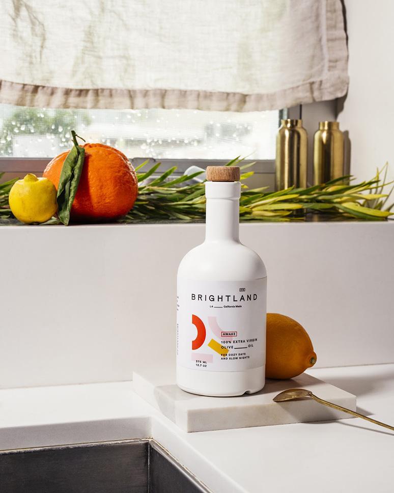 olive oil and oranges on counter