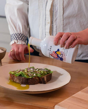 pouring olive oil over toast